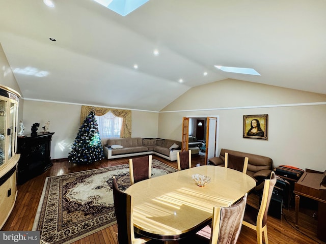 dining room featuring lofted ceiling with skylight and dark wood-style floors