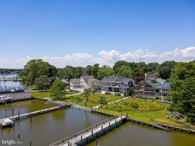 drone / aerial view featuring a residential view and a water view