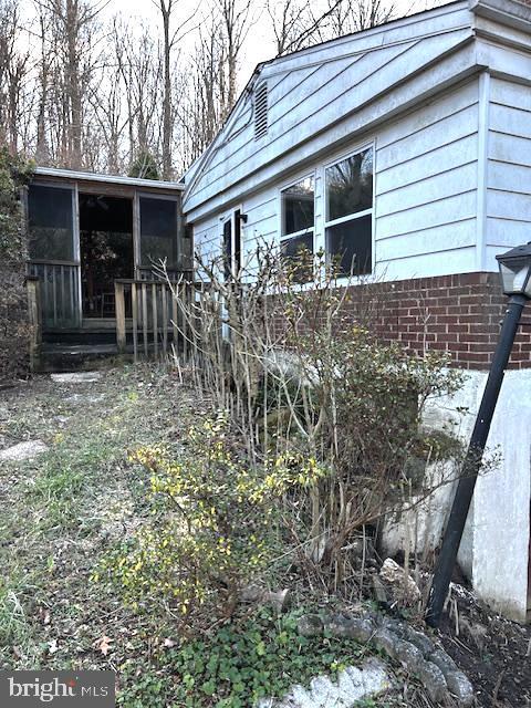 view of side of home with a sunroom