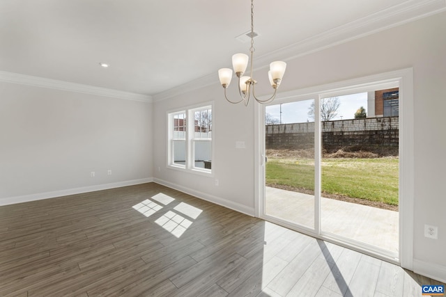 unfurnished dining area with ornamental molding, dark wood-type flooring, and a chandelier