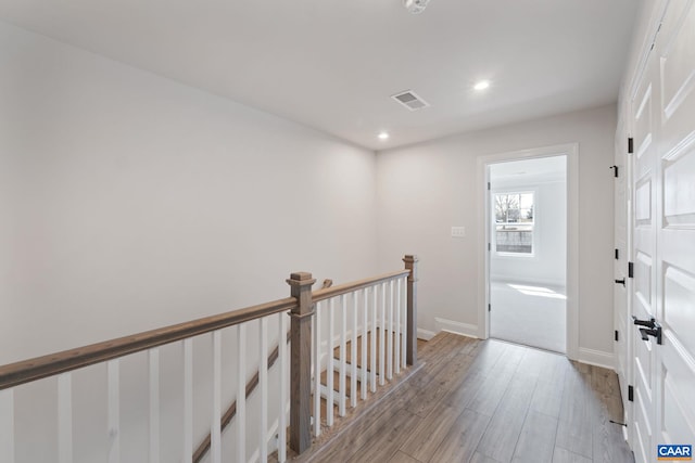 hall with light hardwood / wood-style floors