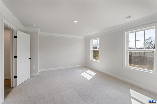 carpeted spare room featuring crown molding