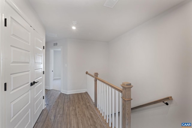 corridor with light hardwood / wood-style floors