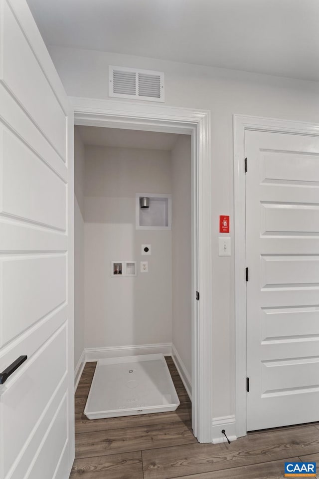 laundry area with electric dryer hookup, washer hookup, and dark hardwood / wood-style floors