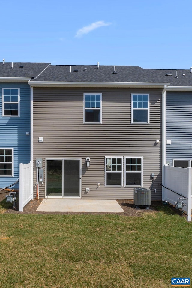 back of house featuring a lawn, a patio, and central AC unit