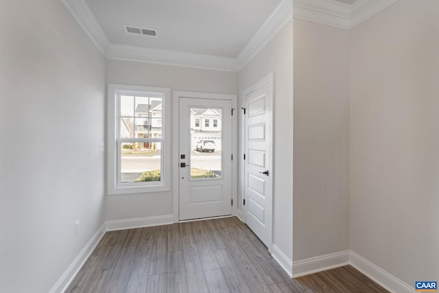 entryway with wood-type flooring and crown molding