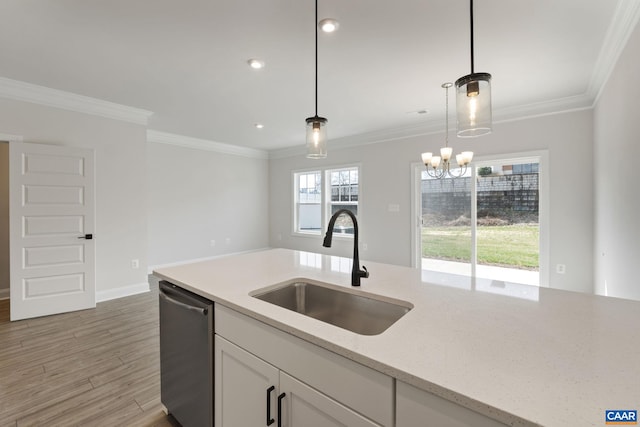 kitchen featuring stainless steel dishwasher, decorative light fixtures, white cabinets, and sink