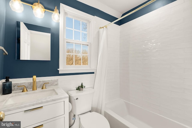 full bathroom featuring tile walls, toilet, vanity, and shower / tub combo