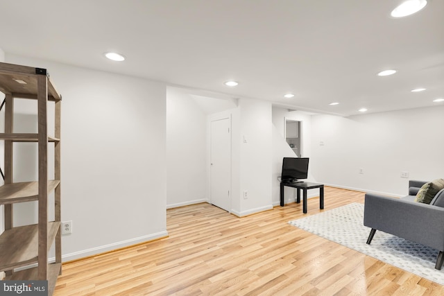 living area with recessed lighting, baseboards, and wood finished floors