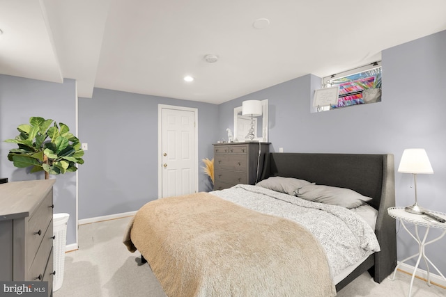 bedroom featuring light colored carpet and baseboards