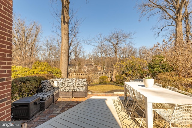 wooden terrace featuring an outdoor living space and outdoor dining space