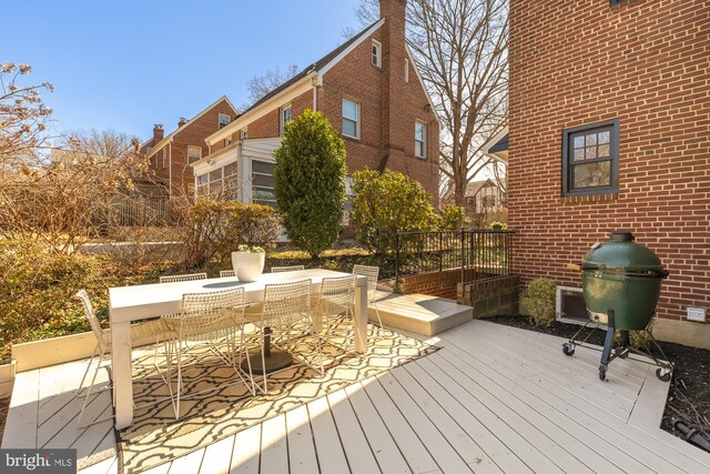 deck with area for grilling and outdoor dining area