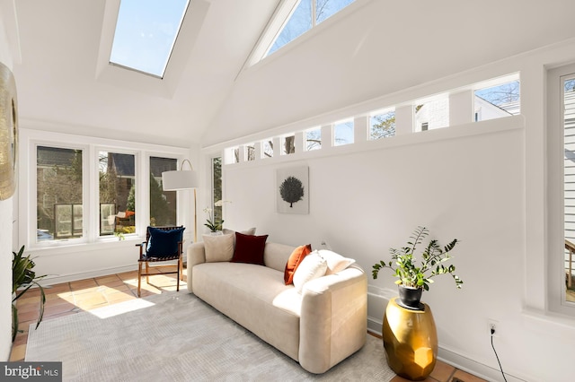 sunroom / solarium featuring lofted ceiling with skylight