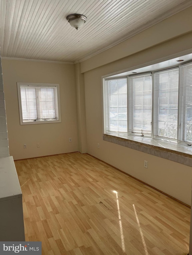 unfurnished room with wood ceiling, crown molding, and light hardwood / wood-style flooring