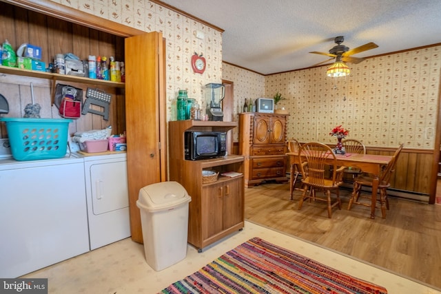 clothes washing area with washer and clothes dryer, ceiling fan, ornamental molding, and a textured ceiling