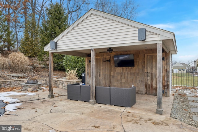 view of outbuilding featuring an outdoor living space with a fire pit