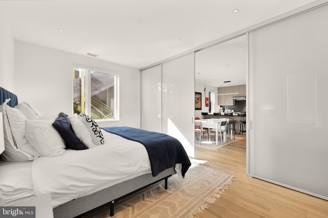 bedroom featuring a closet and light wood-type flooring