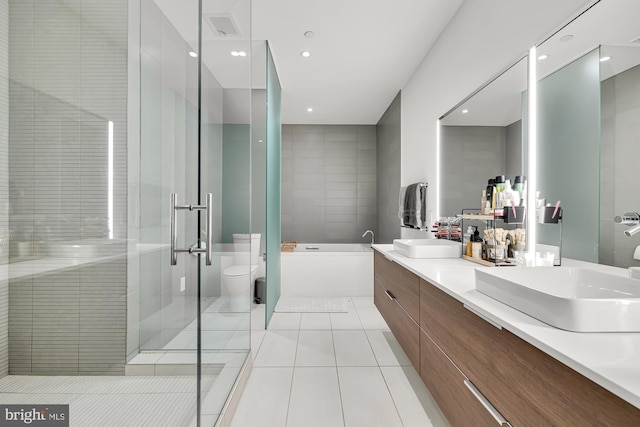 full bathroom with toilet, tile patterned floors, independent shower and bath, and vanity