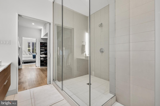 bathroom featuring vanity, tile patterned floors, and a shower with shower door