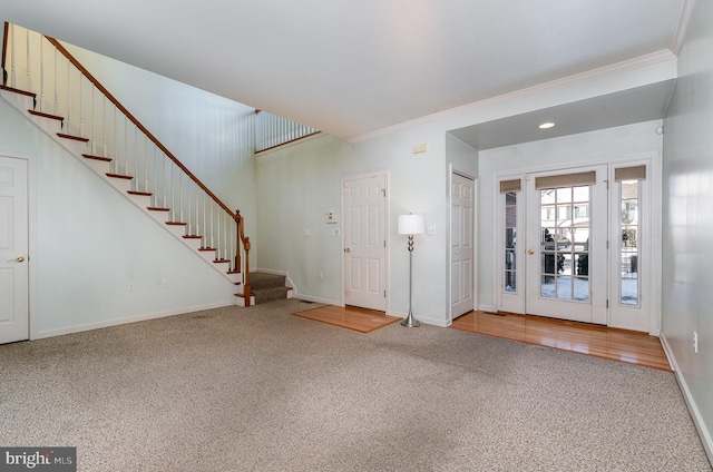 entryway with carpet flooring and ornamental molding