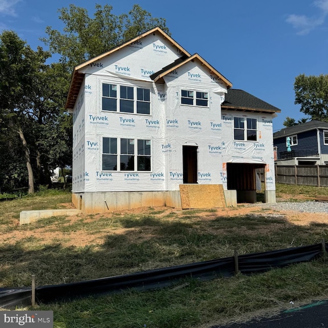 unfinished property with a front yard and fence