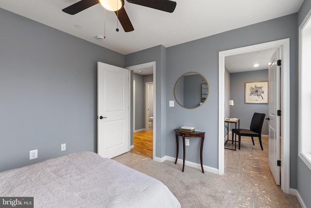 bedroom featuring a ceiling fan, light colored carpet, and baseboards