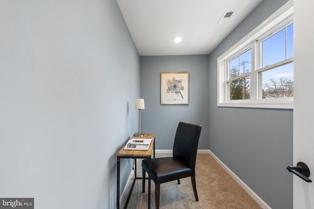 carpeted office space featuring visible vents and baseboards