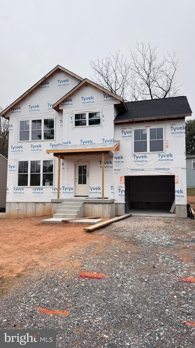 property under construction featuring driveway and an attached garage