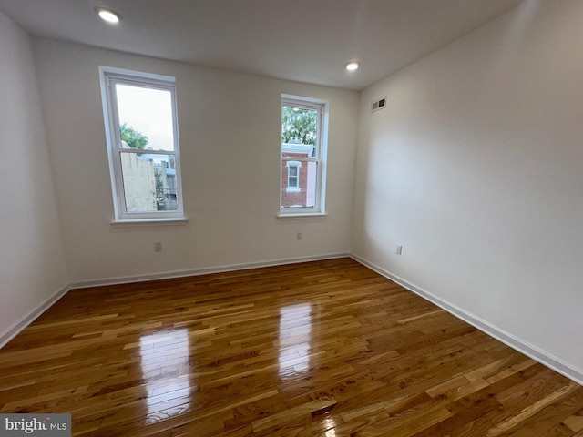 spare room with dark wood-type flooring