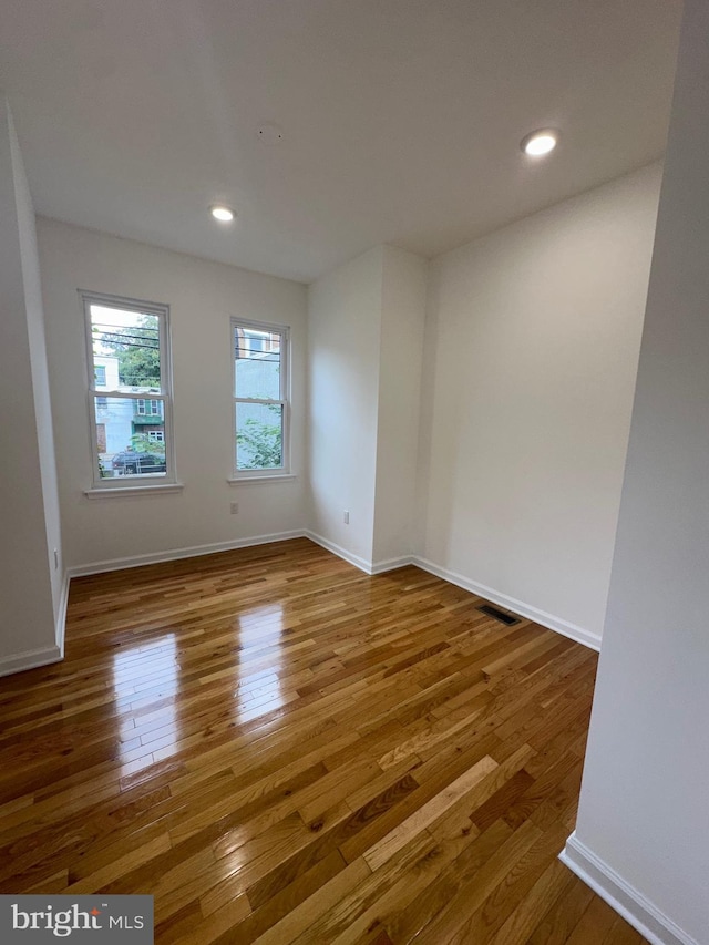 unfurnished room featuring hardwood / wood-style flooring