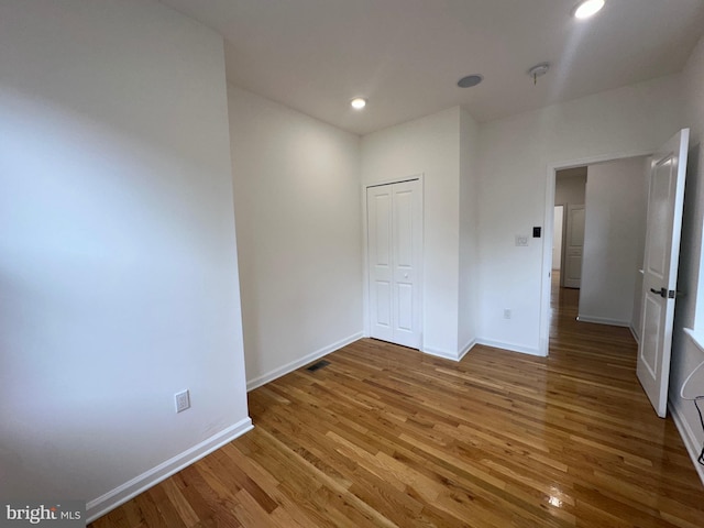 spare room featuring hardwood / wood-style floors