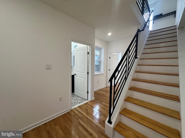 stairway with hardwood / wood-style flooring