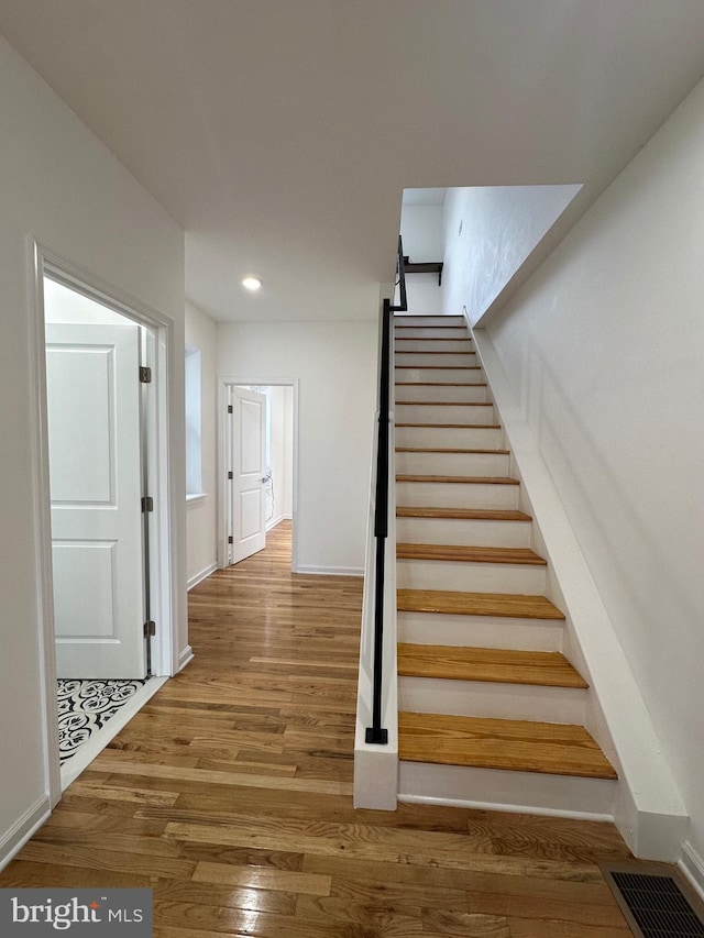 stairs with wood-type flooring