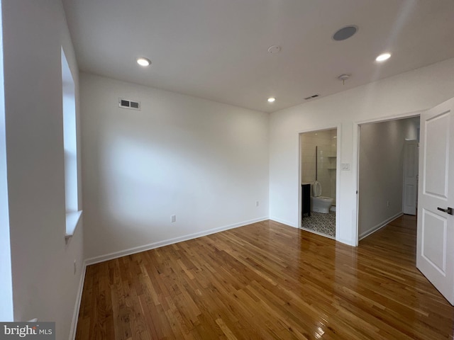 unfurnished room with dark hardwood / wood-style flooring