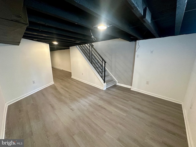 basement with hardwood / wood-style flooring