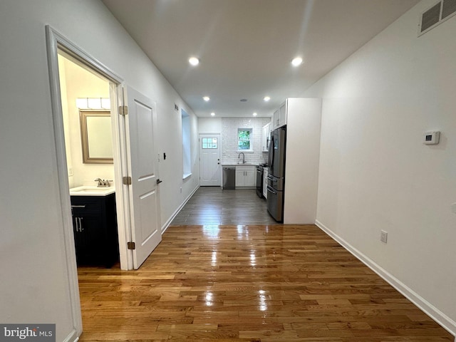 hallway featuring sink and dark hardwood / wood-style floors