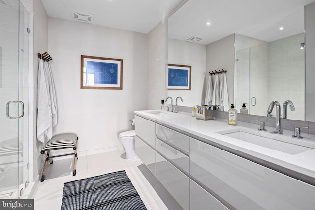 bathroom featuring toilet, vanity, tile patterned floors, and walk in shower