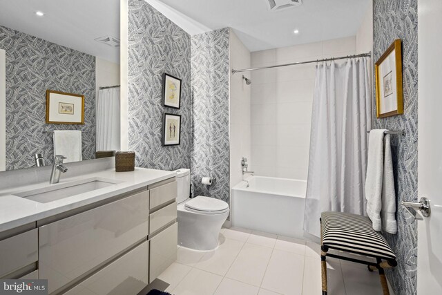 full bathroom featuring tile patterned floors, vanity, toilet, and shower / tub combo with curtain