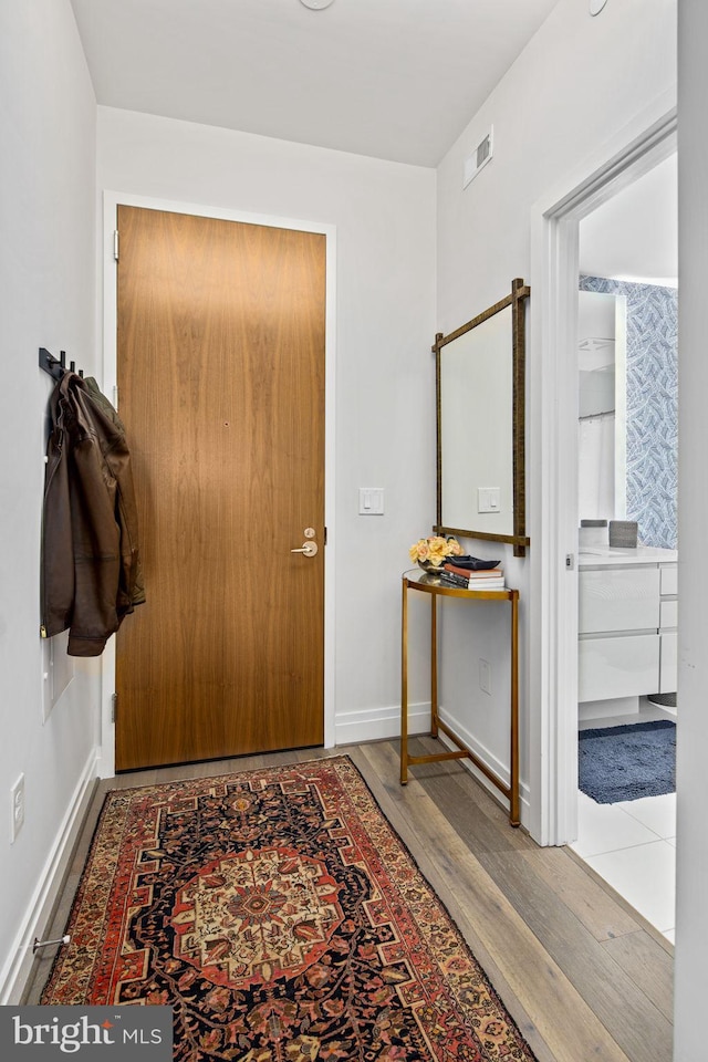 entryway with wood-type flooring