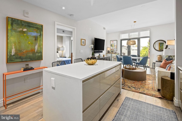 kitchen featuring pendant lighting, a center island, and light hardwood / wood-style floors