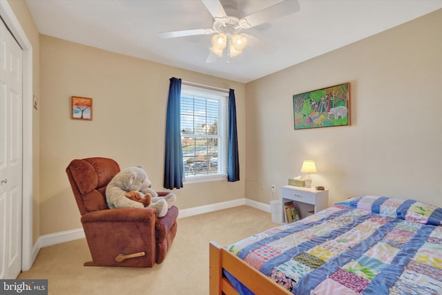 bedroom with light carpet, ceiling fan, and a closet