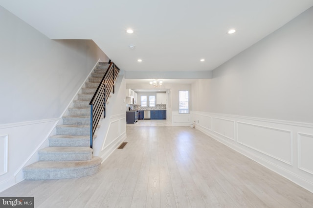 interior space featuring light hardwood / wood-style floors and a notable chandelier