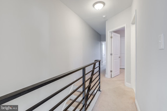 hallway featuring light colored carpet