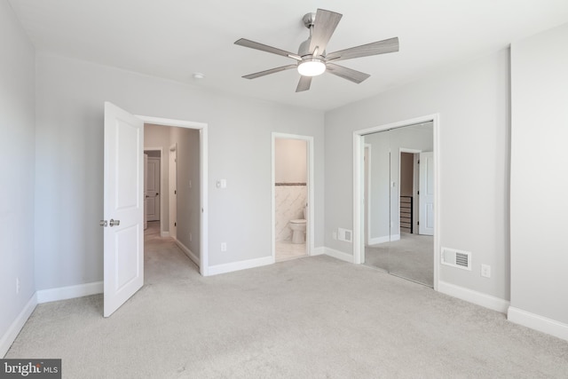 unfurnished bedroom with connected bathroom, ceiling fan, and light carpet