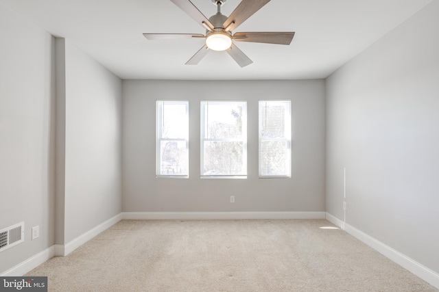 carpeted spare room with ceiling fan