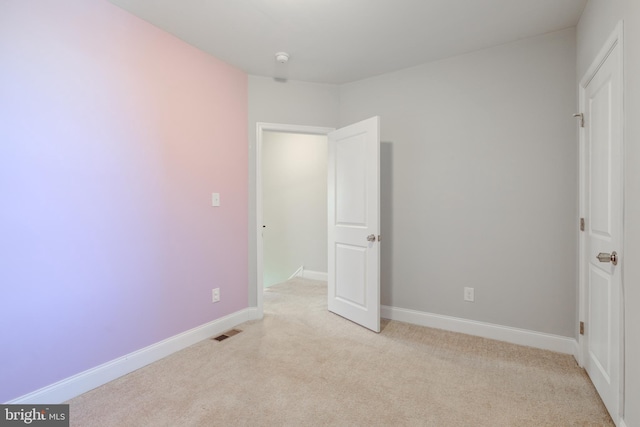 unfurnished bedroom featuring light carpet