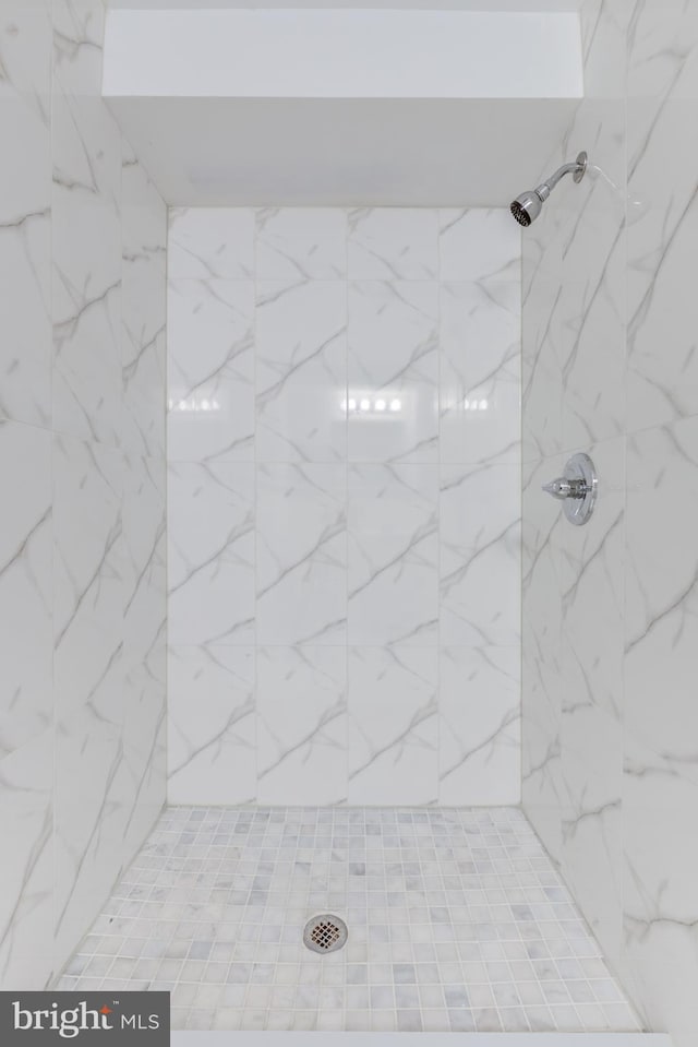 bathroom with tiled shower