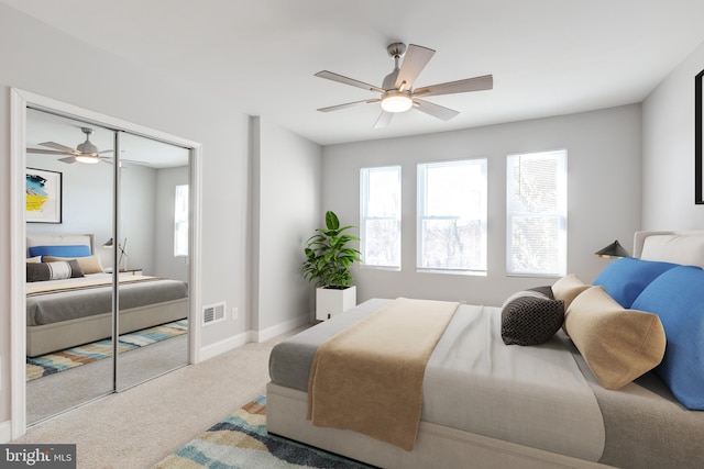 carpeted bedroom featuring ceiling fan and a closet