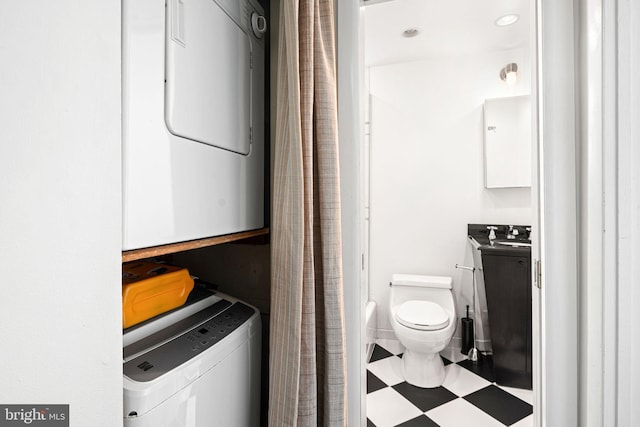 laundry area with stacked washer and dryer