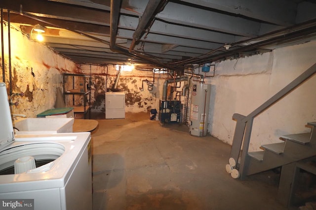 basement with water heater and independent washer and dryer